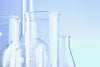 Empty chemistry bottles against blue background