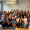 Blueland employees smiling for a large group photo